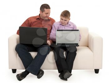 Royalty Free Photo of a Father and Son Sitting With Laptops