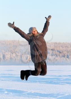 Royalty Free Photo of a Young Girl Jumping in the Snow