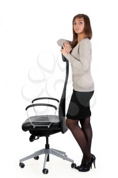 Royalty Free Photo of a Woman Standing by an Office Chair