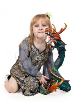 Royalty Free Photo of a Girl With a Dragon Statue
