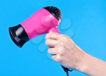 Royalty Free Photo of a Woman Holding a Hair Dryer
