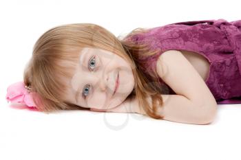 beautiful girl aged four years lying on the floor. Isolate on white
