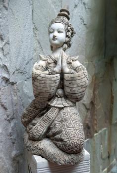 Asian statue in the form of a girl praying