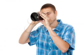 Handsome young man looking through a telescope isolated on a white background