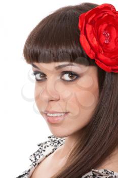 beautiful young brunette woman with an red fabric flower in her hair
