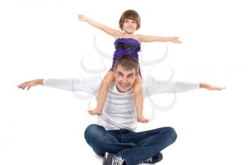 Handsome father with his little daughter on his shoulders happily laughing in the studio. Isolate on white.