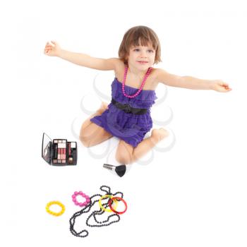 Cute little girl with makeup, necklaces and bracelets is in adulthood. Studio portrait, isolate on white.