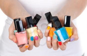 woman hand holding colorful nail-polish