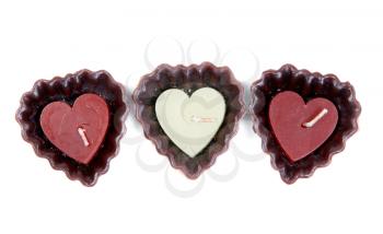 three candles in the shape of a heart isolated on white background
