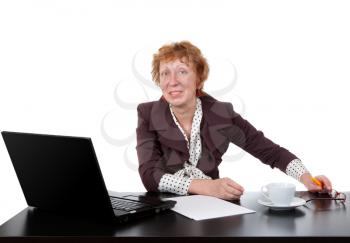 Middle-aged woman at the table, a laptop in the studio on a white background