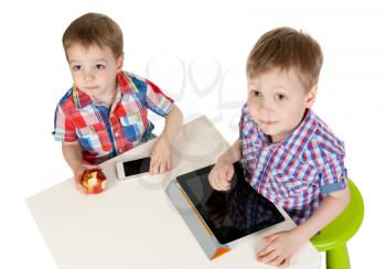 Two brothers with a Tablet PC in the studio on a white background