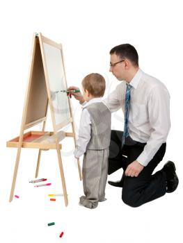 Businessman teaches his son to paint on an easel, isolate on white