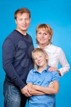 Happy family father, mother and son on a blue background