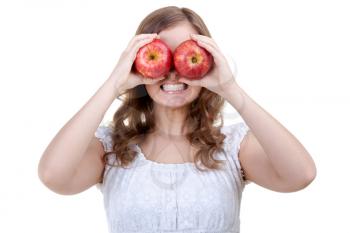 Young girl holding apple in front of the teeth shows