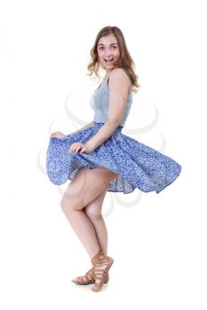 girl lifts dress in the studio on a white background