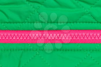 pink zipper on the green quilted fabric