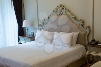 room at the luxurious double bed with carved headboard.