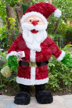 Santa Claus figure on the background of tropical trees