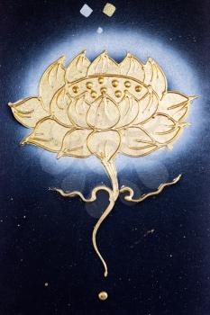 golden flower painted on a dark canvas.