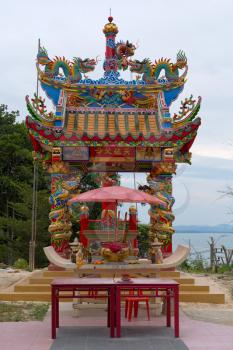 Chinese-style temple in the jungle on a hillside overlooking the sea