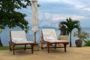 two sun loungers on an overcast day at the beach on the island of Koh Chang, Thailand