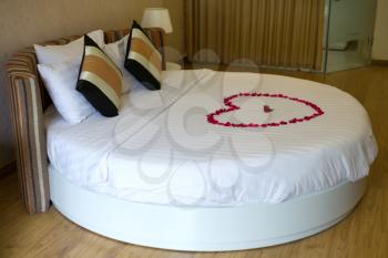 Honeymoon round bed topped with rose petals