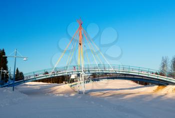 Bridge on the background of a winter landscape on a sunny day