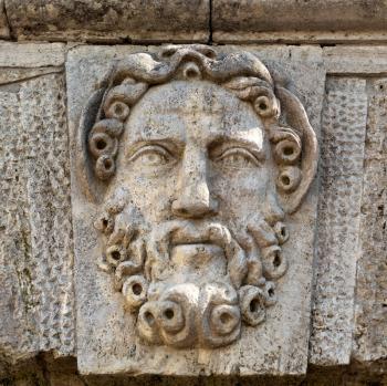 sculpture in stone face with a beard close-up