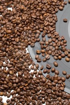 Coffee beans and vintage vinyl record on white background.