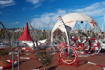 Amusement park in the port of Barcelona on a sunny day with blue sky with clouds.
