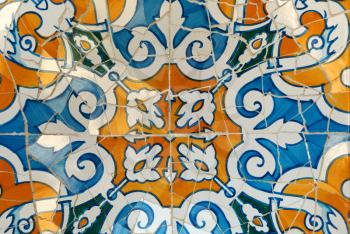 Detail of a mosaic on the wall. Guadi in park Guell Barcelona, Spain
