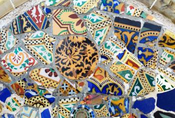 Close-up of the ceramics in Park Guell Barcelona created by Gaudi. Detail of a mosaic on the wall.