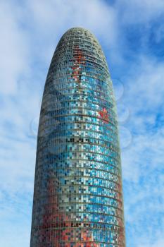 Barcelona, Catalonia, Spain - January 28, 2014: Vertical view of the Agbar Tower (Torre Agbar), a 38-story skyscraper, and one of the main samples of High-Tech architecture in Barcelona city. Agbar To
