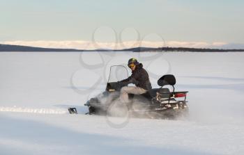 Snowmobile action sport in north Russia. a lot of fun driving those fast snow mobiles over frozen lakes and the snow landscape
