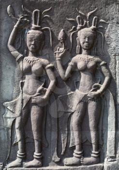 Mural carvings of Aspara dancers on the walls of Angkor Wat Cambodia.
