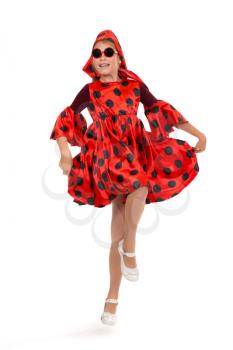 Teen girl dancing in a red polka-dot dress with sunglasses. Isolate on white.
