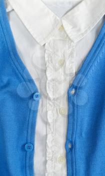 Trendy blue cardigan with a white shirt closeup