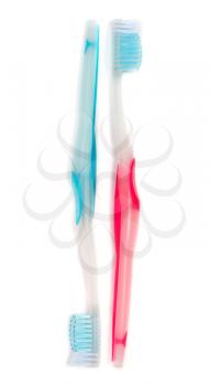 Two colorful tooth-brushes on a white background.