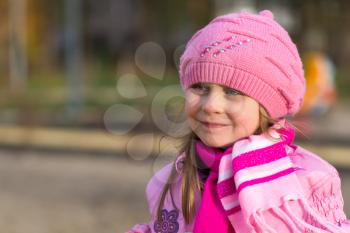 portrait of a pensive little girl in a pink hat