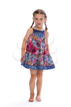 Little girl in a colorful dress in the studio, isolate on white.