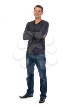 Friendly adult male with his arms folded smiling at the camera - isolated on white