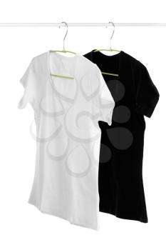 Two, white and black t-shirt on a hanger. Isolate on white.