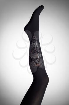 Mannequin female foot in stylish fashion pantyhose with rhinestones