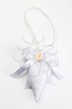 Knit handmade heart on a light gray background.