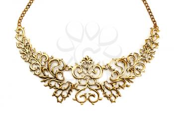 Golden necklace in the shape of tree branches on a white background mirror. Isolate.
