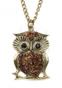 Close up of a gold owl pendant on white