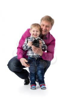 Father and young son with a camera in his hands. Isolate on white.