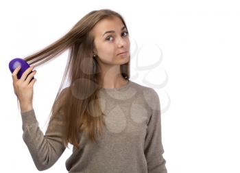 Young girl combing the studio. Isolate on white background.