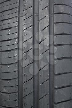 Tread tire for a car close-up.