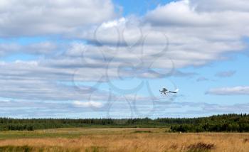 Private propeller aircraft on take-off on the background of clouds